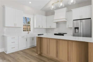 Bright, open-concept kitchen featuring custom cabinetry, quartz countertops, and modern lighting designed for both functionality and everyday family living.