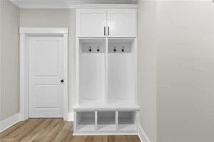Functional drop zone with built-in cabinetry, seating, and storage designed to organize daily essentials while maintaining a clean and cohesive entryway space.